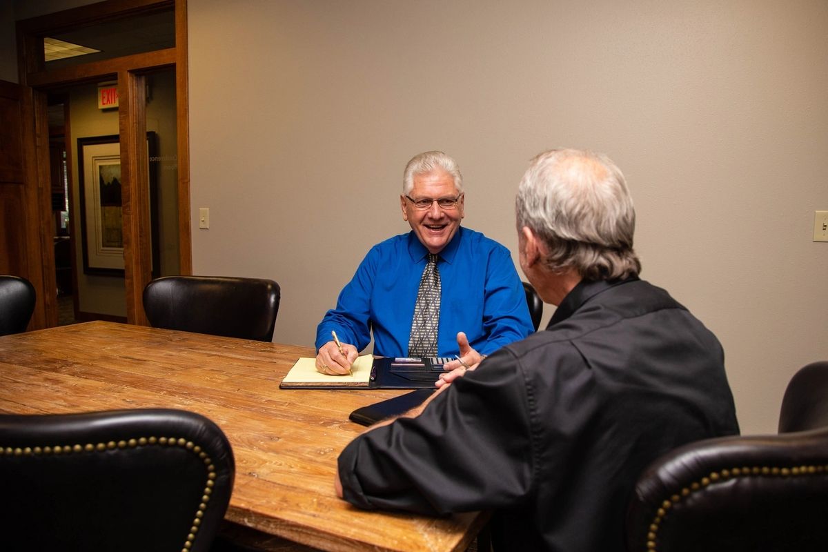 Harlan TenNapel meeting with a client at the Solus Real Estate conference table
